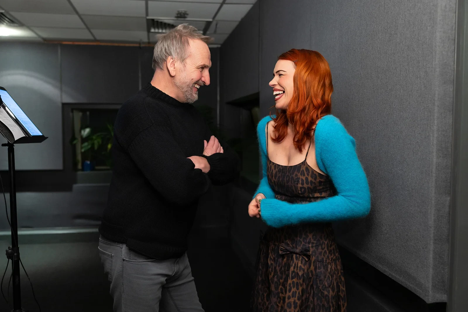 Christopher Eccleston and Billie Piper in a recording studio, smiling at each other